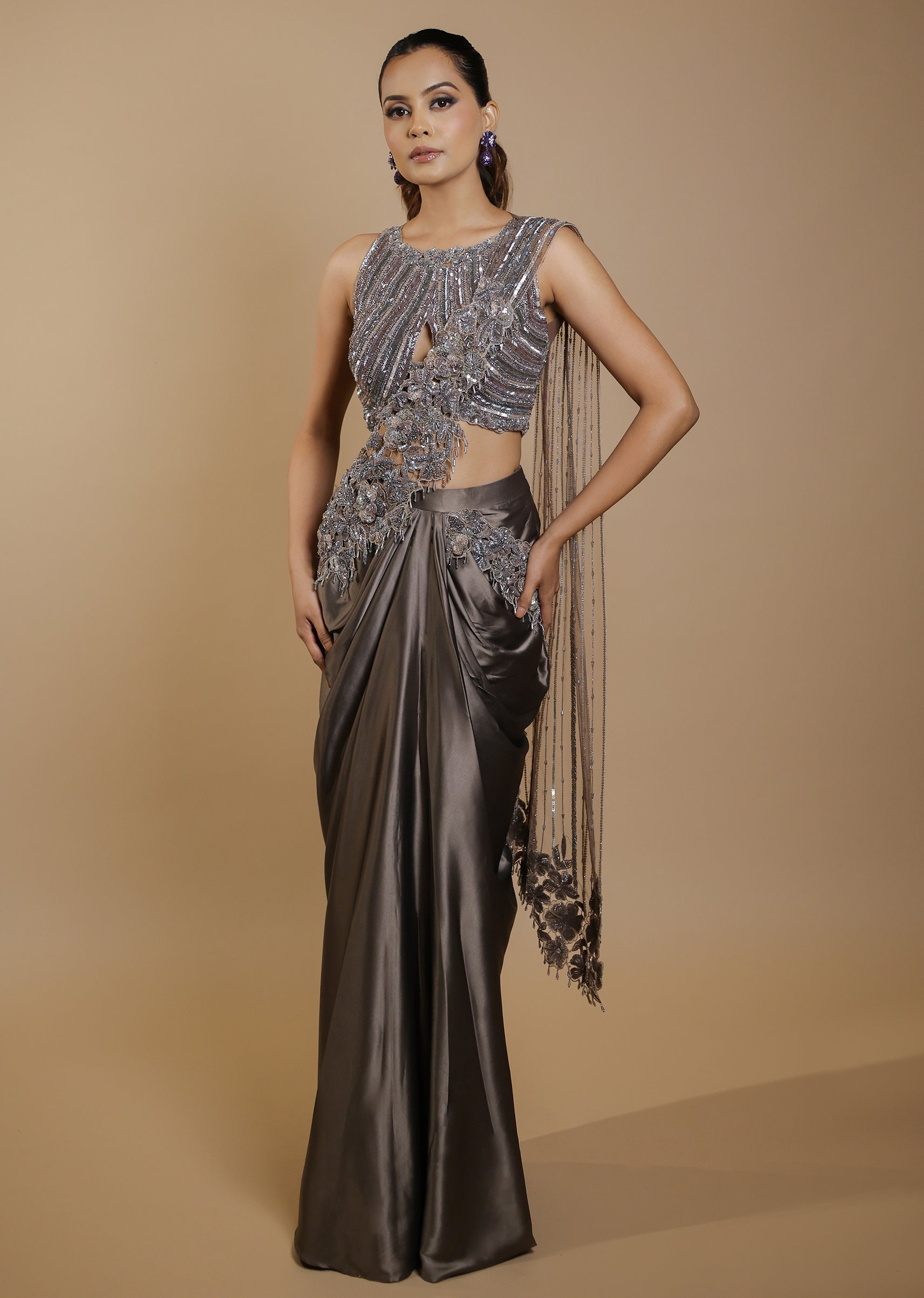Metallic grey draped satin saree gown with embellished cut-out blouse – Jiya by Veer Design Studio