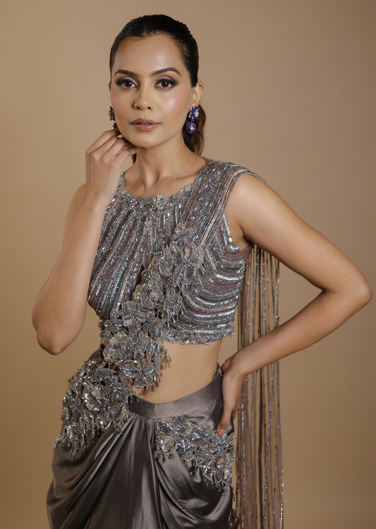 Metallic grey draped satin saree gown with embellished cut-out blouse