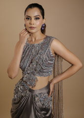 Metallic grey draped satin saree gown with embellished cut-out blouse