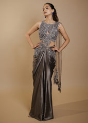 Metallic grey draped satin saree gown with embellished cut-out blouse