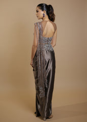 Metallic grey draped satin saree gown with embellished cut-out blouse