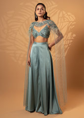 Woman wearing a teal traditional outfit with a textured background